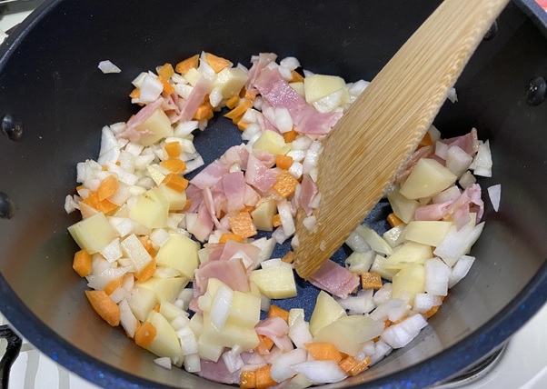 じゃがいも、にんじんと玉ねぎを加え、しんなりとするまでよく炒める。
